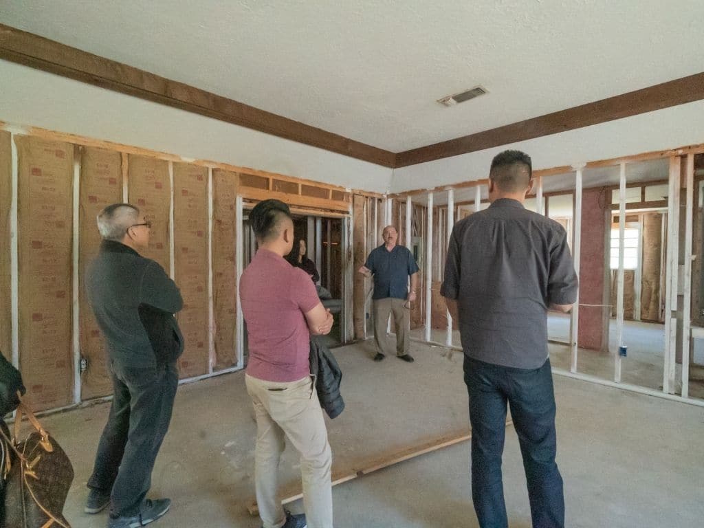 4 men inspecting construction of beaumont, TX single family rental investment property